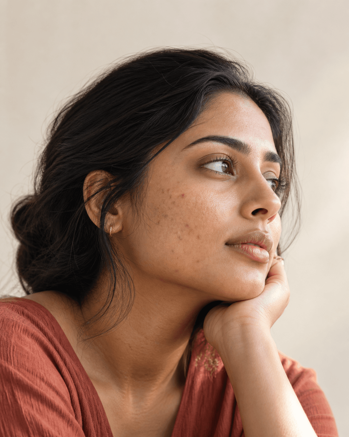Editorial portrait showing subtle lingering post-breakout marks and skin texture