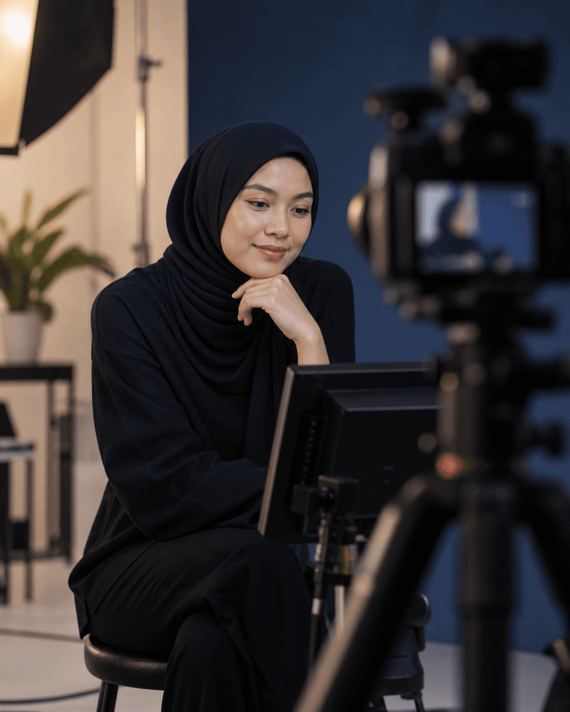A creator preparing calmly in a professional camera setting