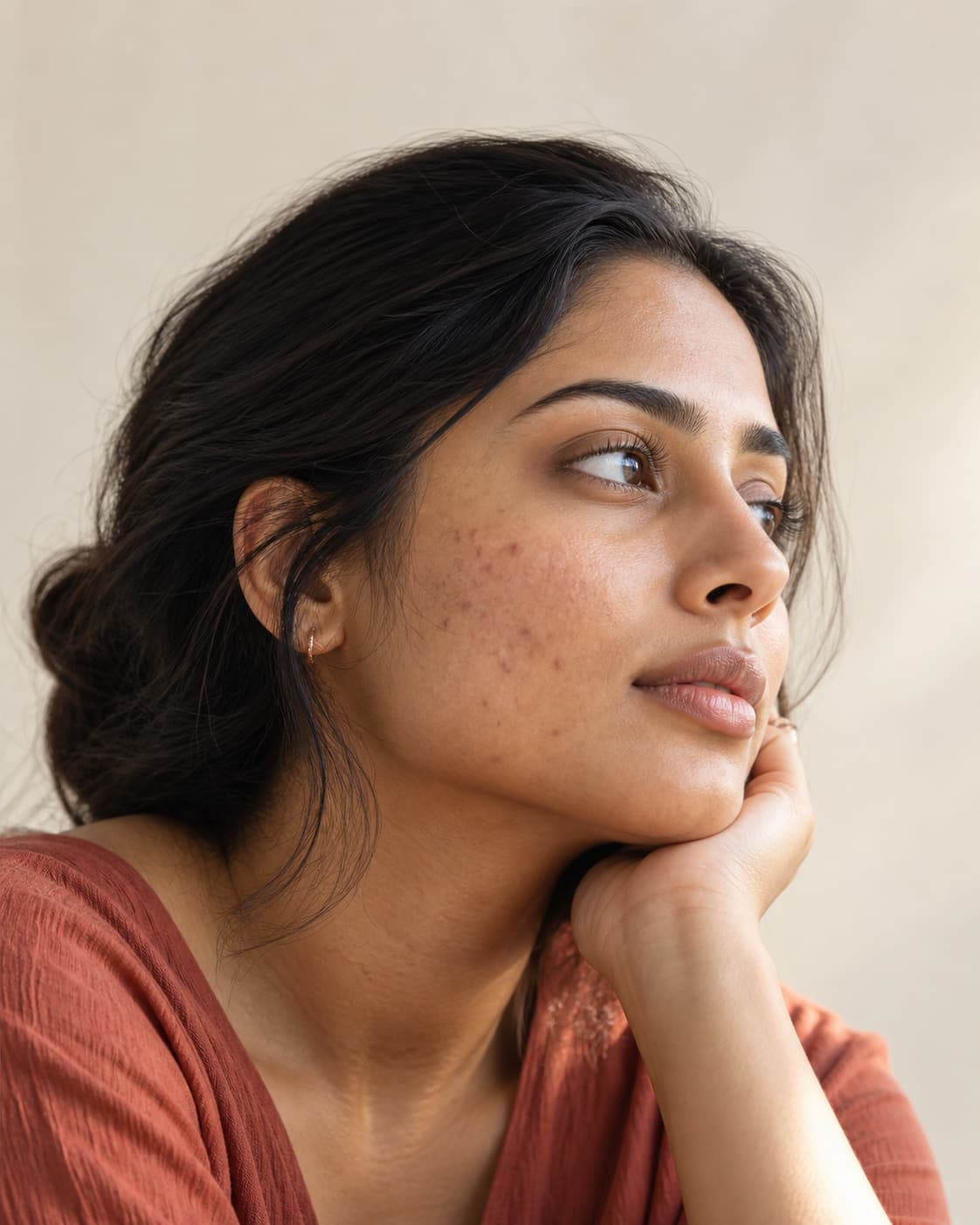 Editorial portrait showing subtle lingering post-breakout marks and skin texture